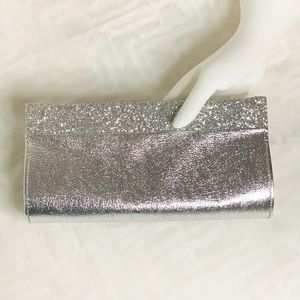 Silver clutch handbag with glitter trim and hinge open and close
